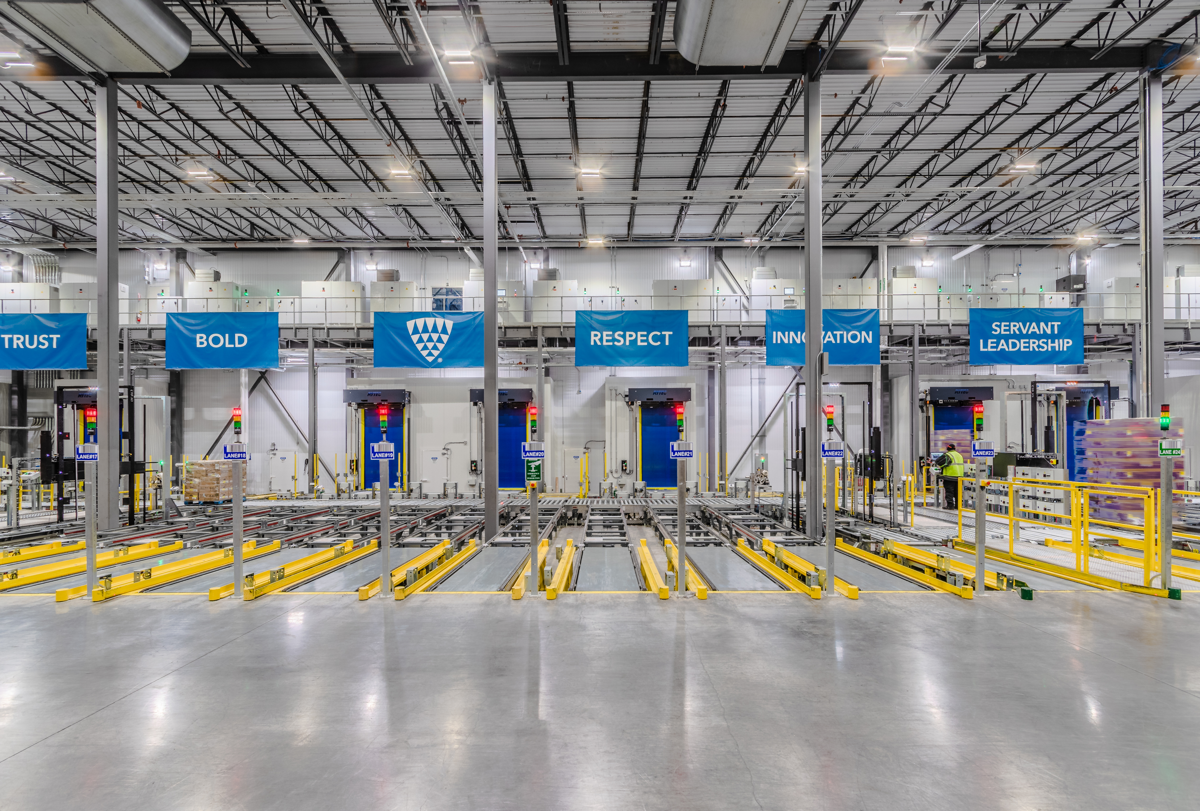 Lineage's values on banners hanging above automated warehouse