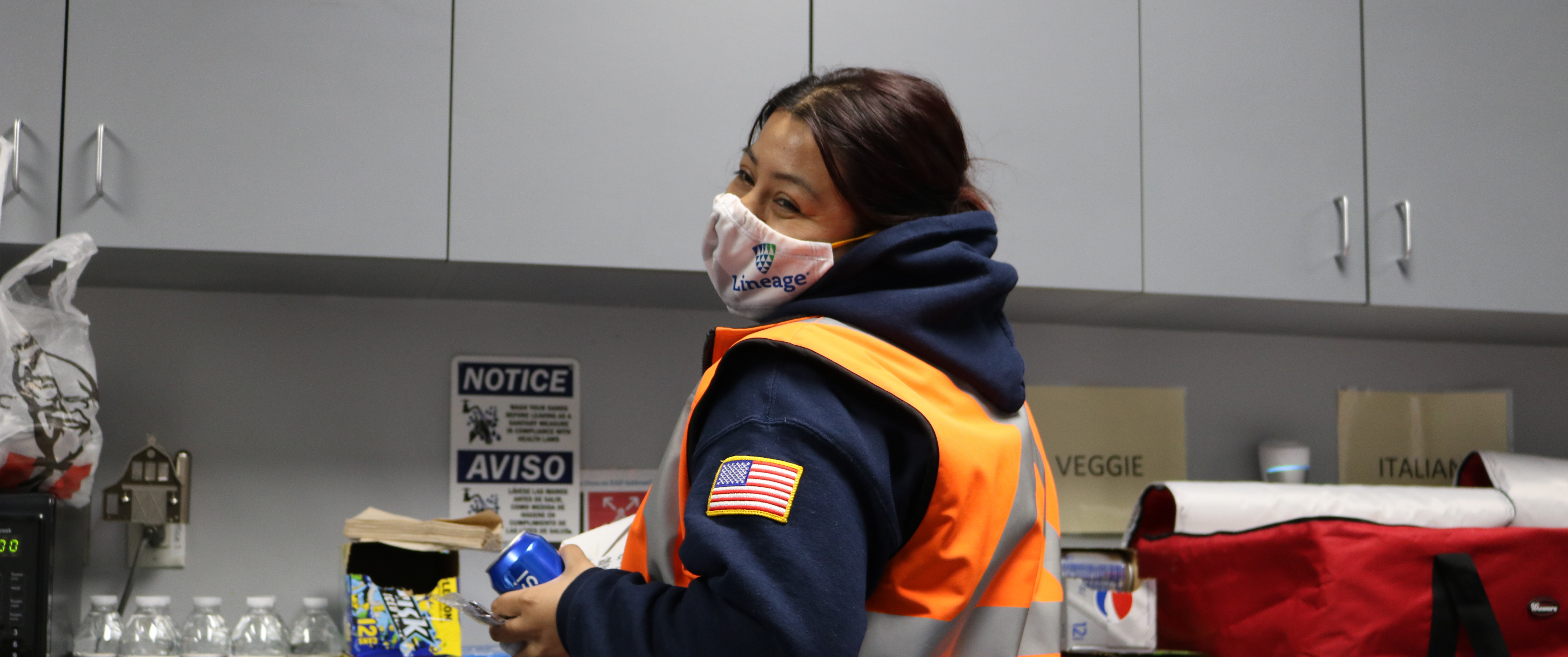 Worker in mask in break room