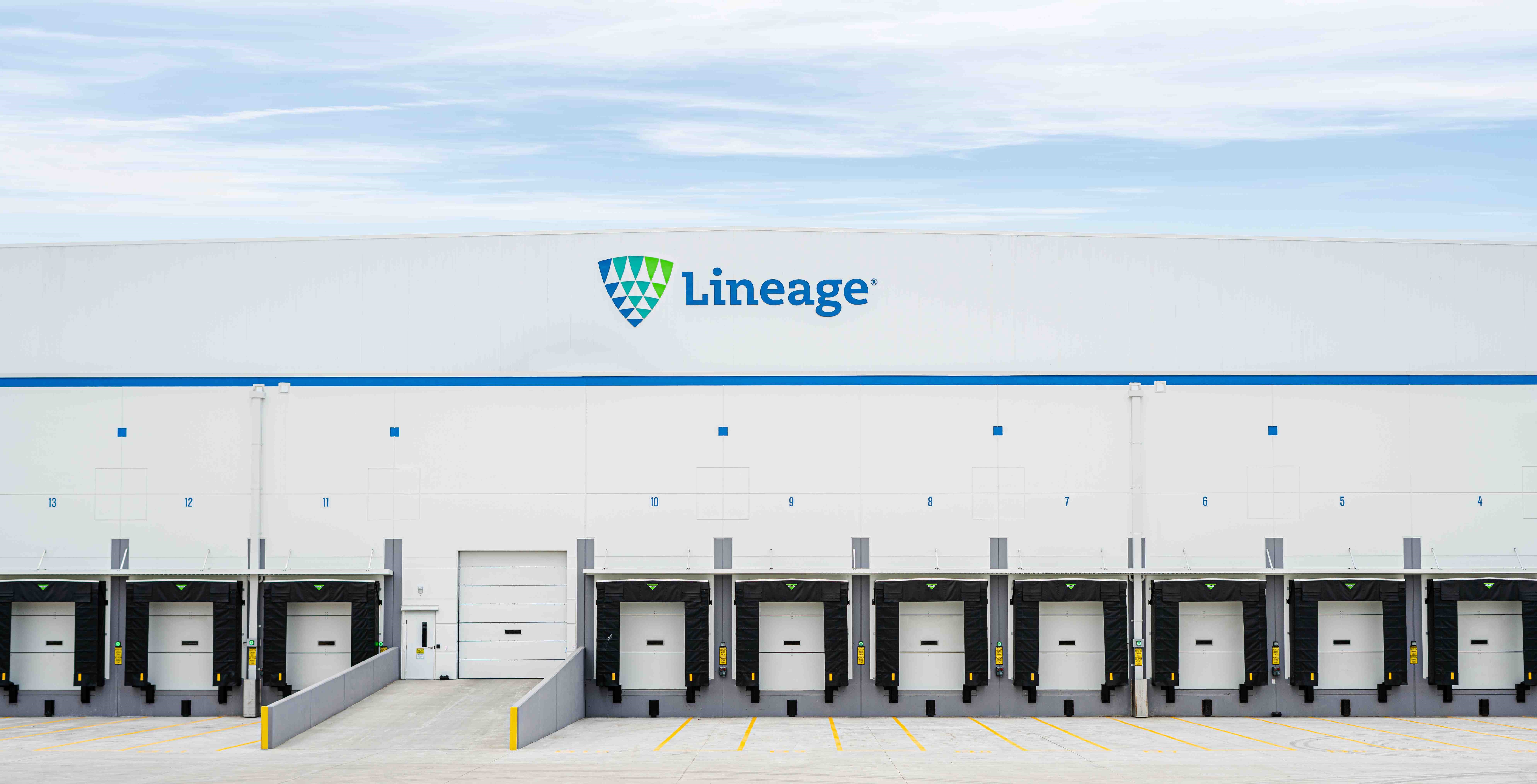 The exterior of a Lineage cold storage warehouse shows several dock doors