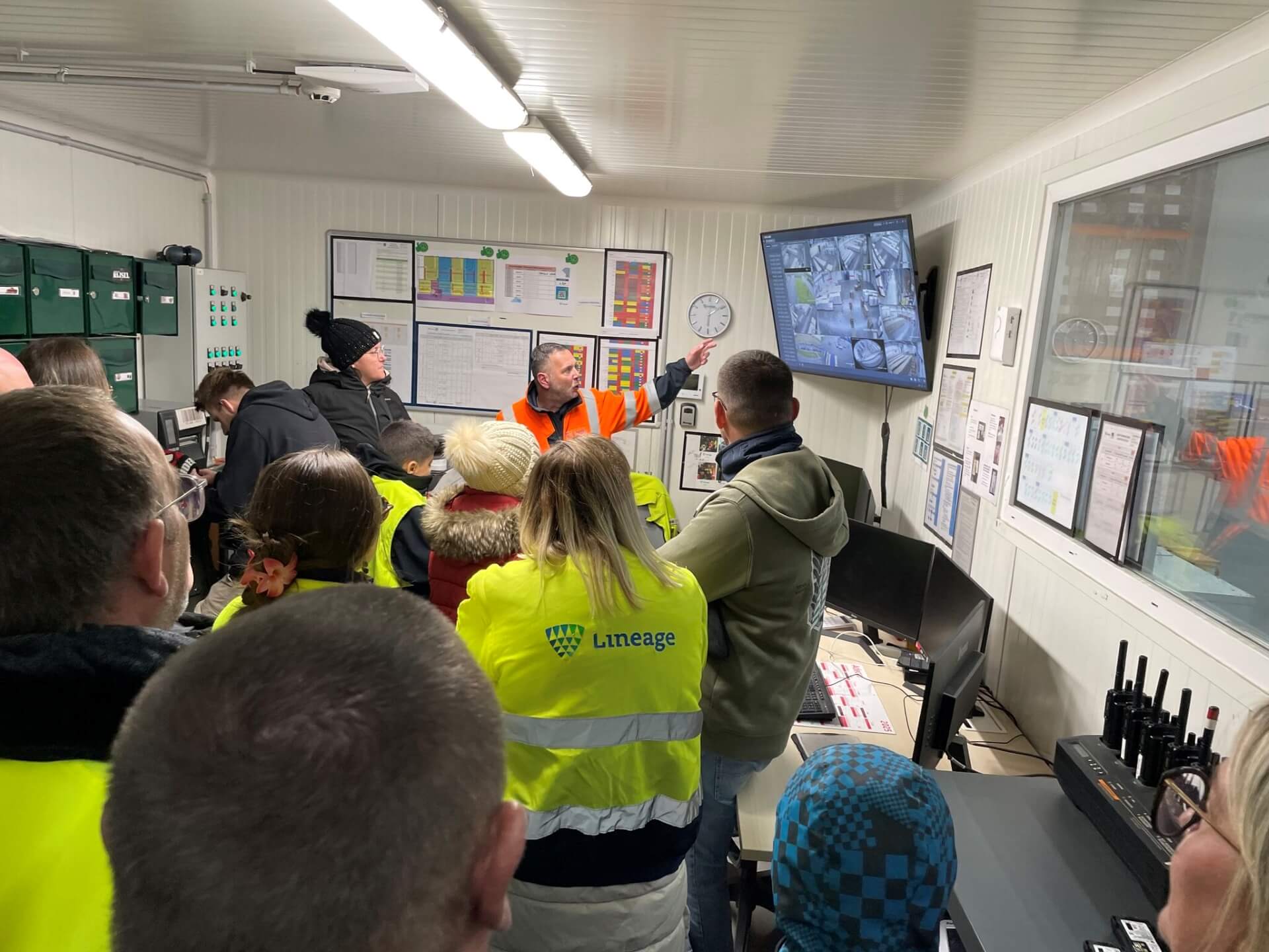 Lineage team member giving a facility tour to employees’ families during Family Day in Harnes, France, showcasing warehouse operations and teamwork.