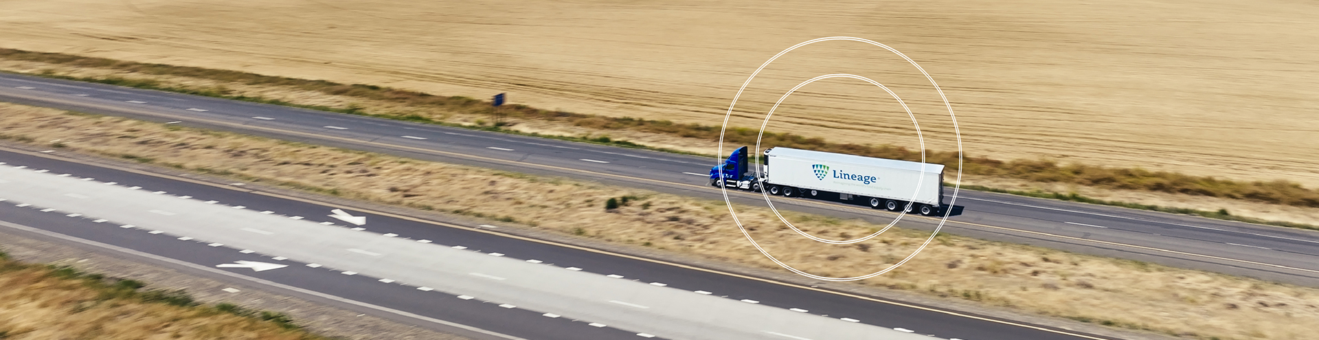 Lineage refrigerated truck driving along a Texas highway, representing Lineage’s statewide cold storage and logistics network.