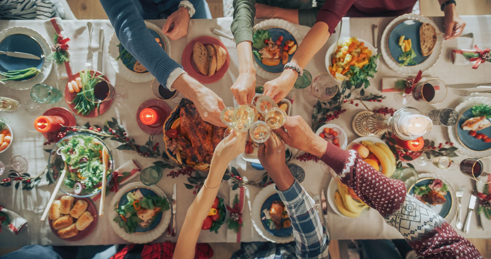 A group of people toast at a holiday feast