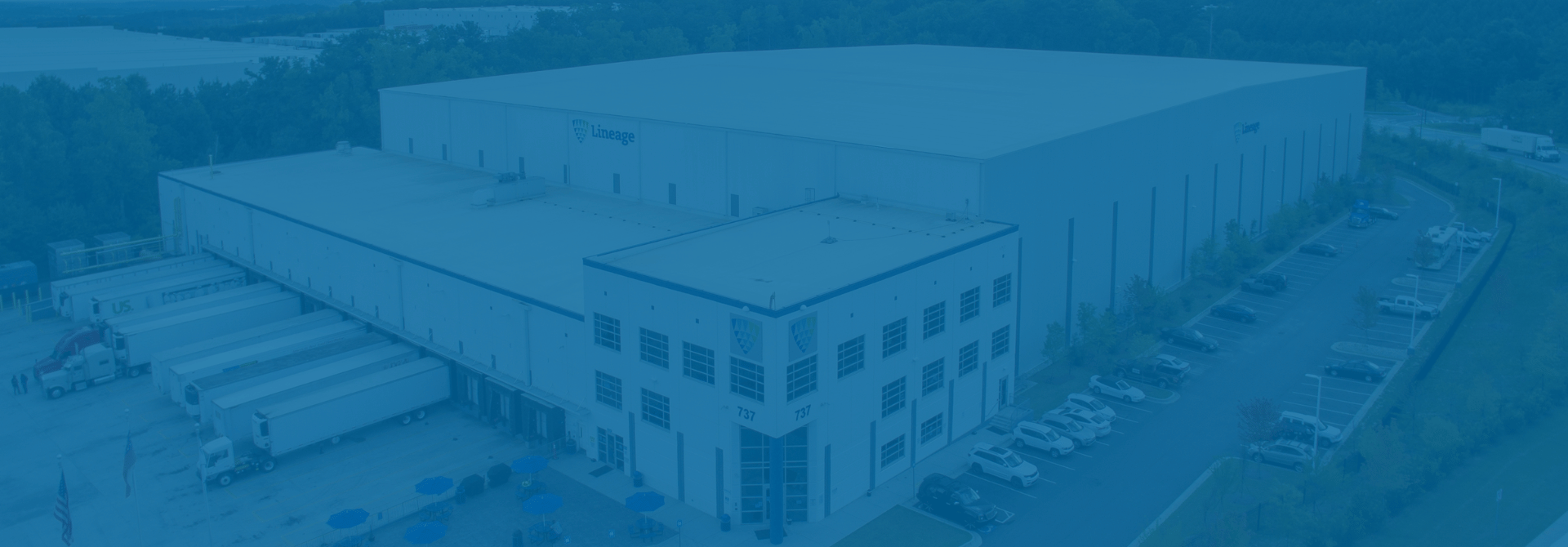 An aerial view of a Lineage cold storage facility with a blue semi-transparent overlay