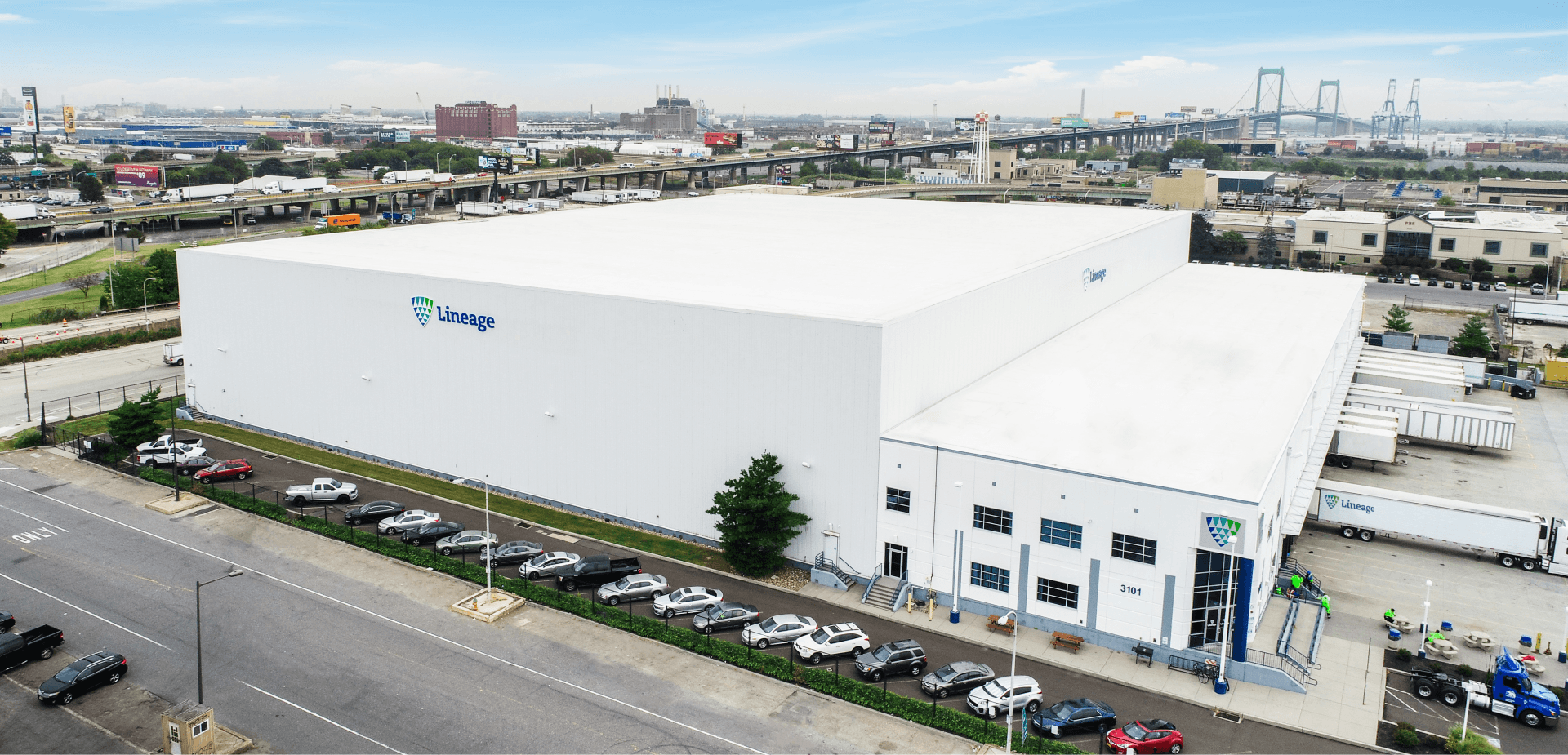 Exterior of Lineage warehouse with city skyline in the background, showing how Lineage's warehouse storage puts your supply chain in the right place.