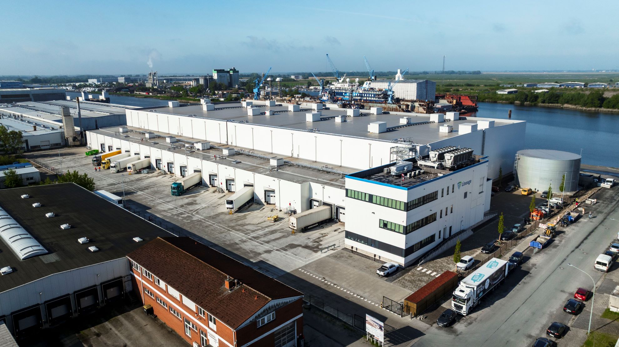 An exterior view of Lineage's cold storage warehouse in Bremerhaven, Germany. The warehouse is located alongside the waterfront.