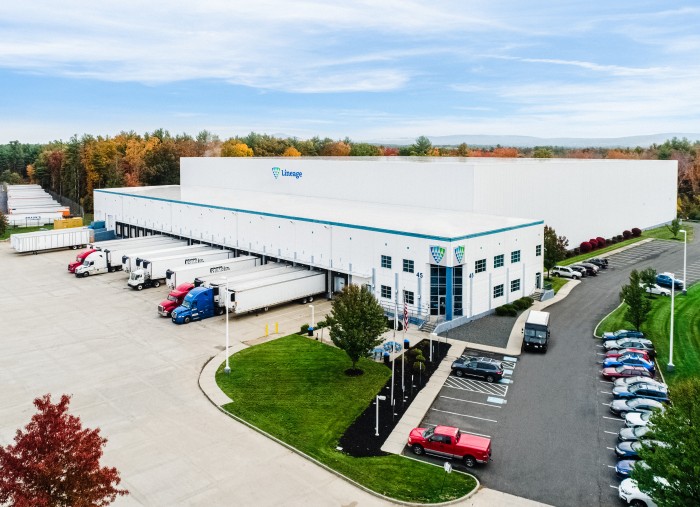 Aerial view of a Lineage cold storage facility in Massachusetts with trucks and trailers at loading docks