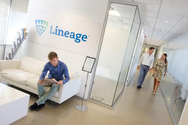 Intérieur de Lineagede Bergen op Zoom aux Pays-Bas avec des membres de l’équipe et une signalisation de marque dans une zone de réception moderne.