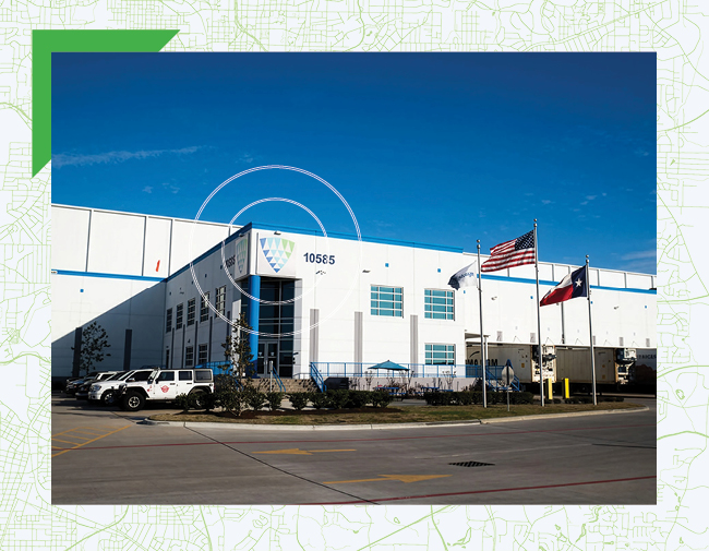 Exterior of a Lineage cold storage facility in Houston, Texas, featuring U.S. and Texas flags, representing Lineage’s Central and Gulf Coast logistics network.