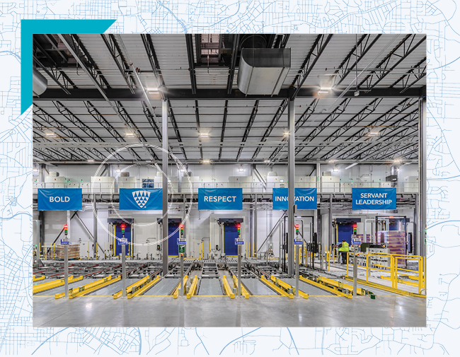 Interior of a Lineage automated cold storage warehouse in Dallas–Fort Worth, Texas, showing pallet lanes and banners highlighting company values like Bold, Respect, and Innovation.
