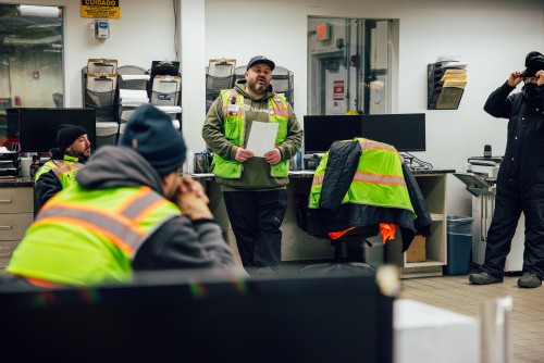 Lineage Bolingbrook team leader addressing warehouse associates during a team meeting inside the facility office.