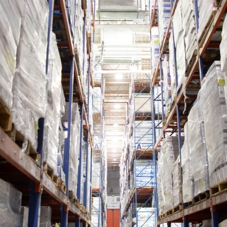 Interior of a bonded cold storage warehouse with palletized food products stored on high racks, supporting compliant temperature-controlled import and export operations.