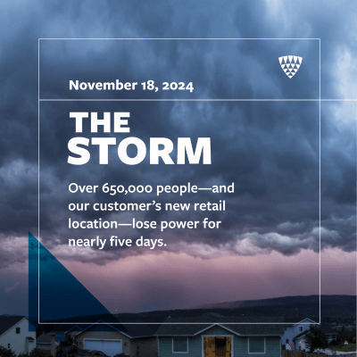 Graphic titled “The Storm” with date November 18, 2024. Text reads: “Over 650,000 people—and our customer’s new retail location—lose power for nearly five days.” Background shows a dark, cloudy sky over a suburban neighborhood.