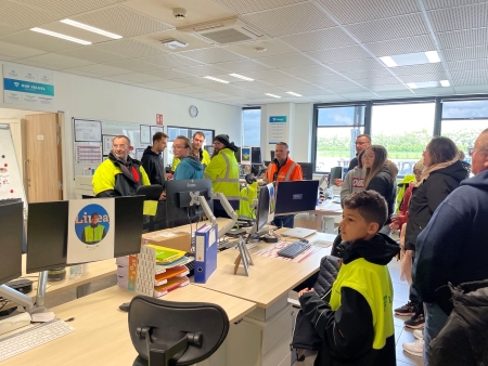Families and team members touring the Lineage office in Harnes, France during Family Day, learning about daily operations and celebrating workplace culture.