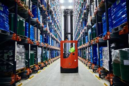 A team member operates material handling equipment in a Lineage cold storage facility