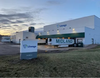 Lineage's Moncton cold storage facility at 123 Price Street, New Brunswick, featuring the company’s signage, loading docks, and parked trailers under an early morning sky.