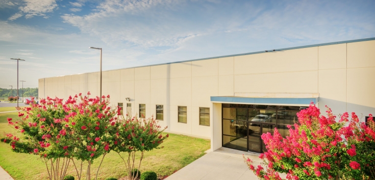 Photo of main entrance to Decatur, AL facility with flowers in bloom