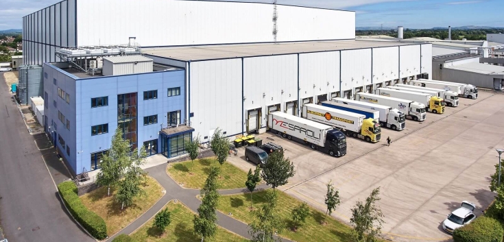 Aerial view of Lineage’s cold storage facility in Gloucester, UK, showing extensive loading dock area and warehouse surrounded by residential and green space