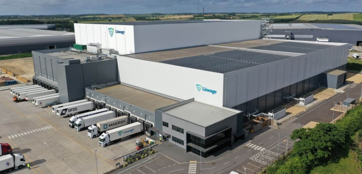 Overhead view of Lineage’s Peterborough cold storage warehouse with rooftop solar panels, surrounded by modern industrial buildings and roads.