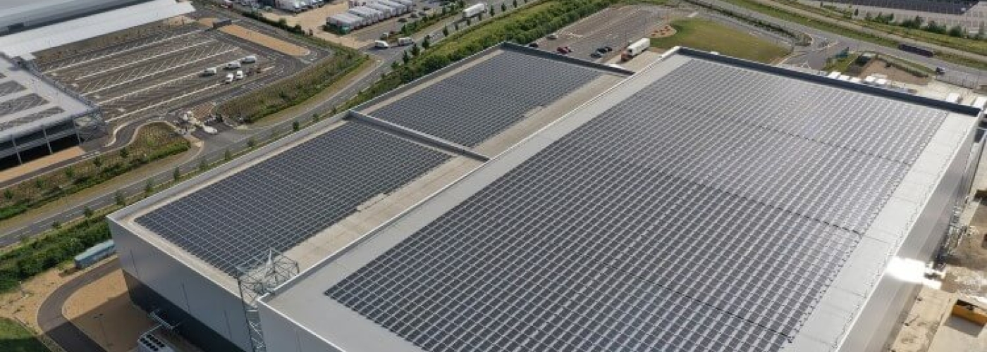 Lineage’s Peterborough cold storage facility with solar panels, loading bays, and branded trucks.