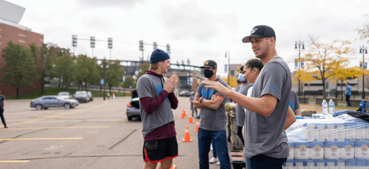 Detroit Lions quarterback Jared Goff with volunteers at Lineage Foundation for Good food insecurity event.