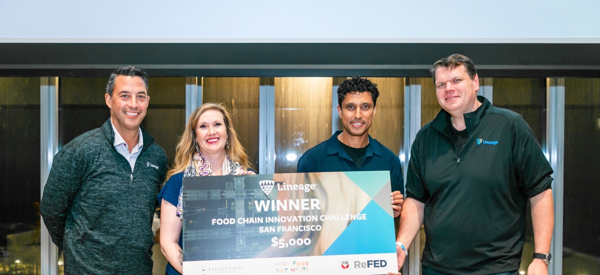 The winners of Lineage's Food Chain innovation Challenge hold a large check alongside company COO and Chief Data Scientist