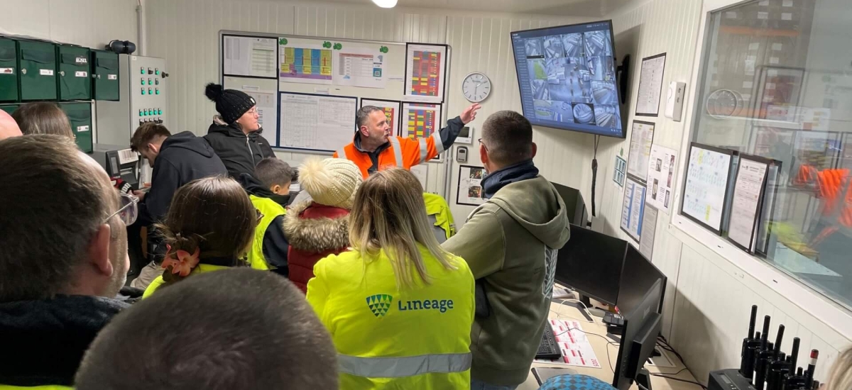 Lineage team member giving a facility tour to employees’ families during Family Day in Harnes, France, showcasing warehouse operations and teamwork.