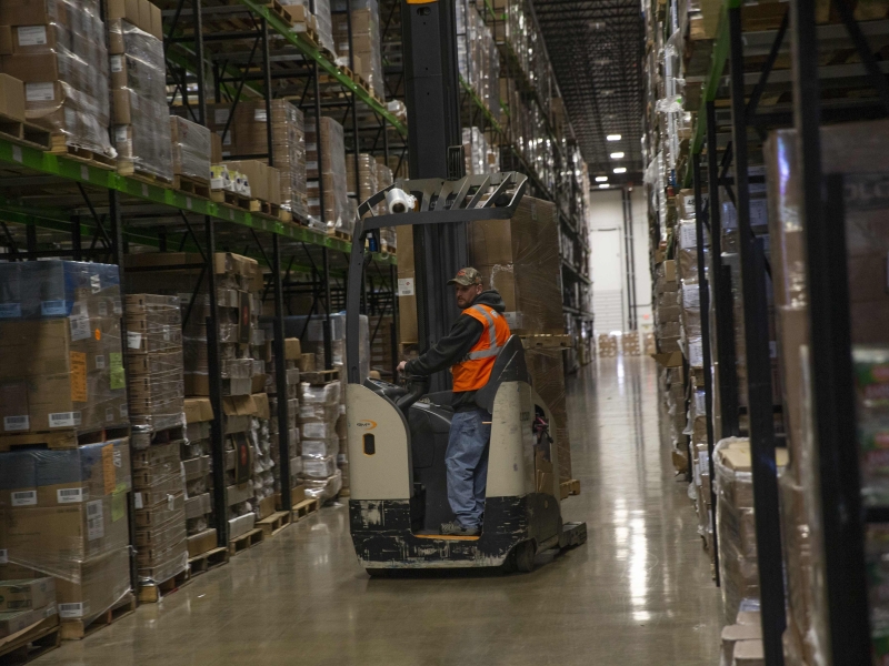 A Lineage team member works in a temperature-controlled warehouse.