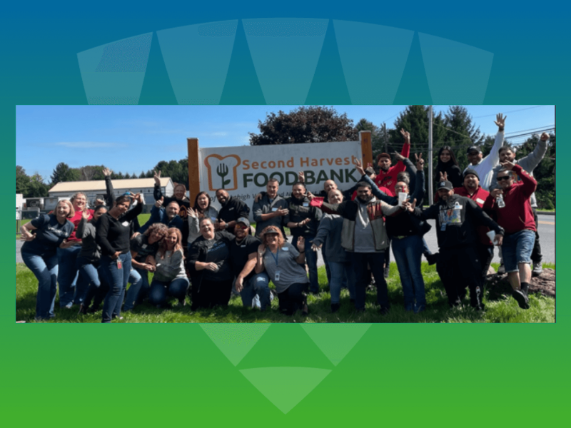  A joyful group of Lineage team members posing outdoors at the Second Harvest Foodbank, celebrating their commitment to community service and team culture. 
