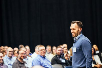 Sean Vanderelzen speaking to a room of team members