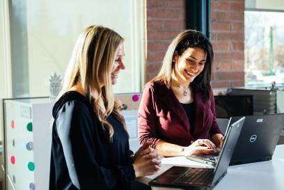 Women working together on laptops at standup desk