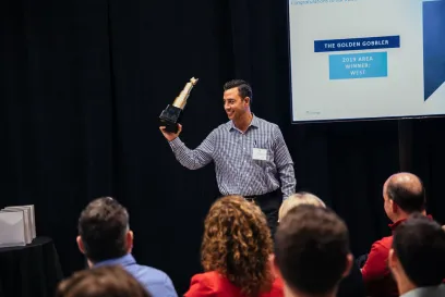 Lineage team member holding an award