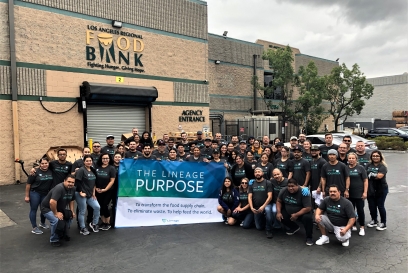 team members holding a banner that says our purpose