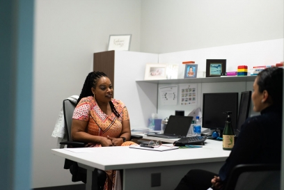 Angie talking to a coworker in her office