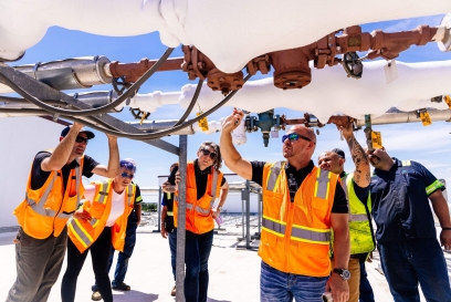 Team of Lineage team members engaged in a facility energy evaluation, inspecting and discussing equipment at Holmewood facility.