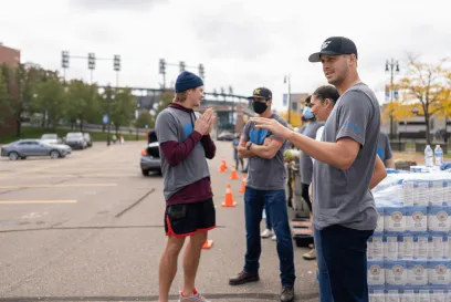 Detroit Lions quarterback Jared Goff with volunteers at Lineage Foundation for Good food insecurity event.