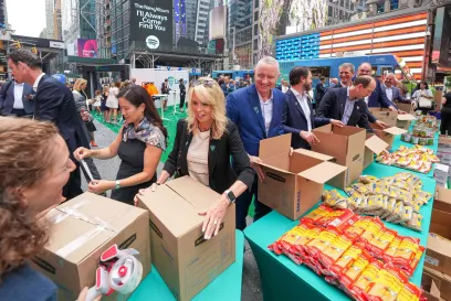 A group of Lineage volunteers pack meal kits in New York City's Times Square