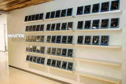 An office wall lined with patent awards