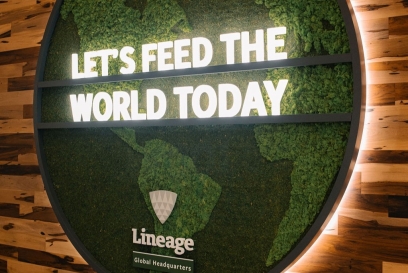 A green map of the world with signage that reads "Let's Feed the World Today" at Lineage Global Headquarters