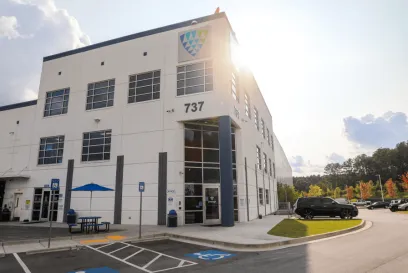 Exterior of a Lineage Logistics cold storage facility in Atlanta, Georgia, showcasing modern architecture and accessibility under a bright afternoon sun.
