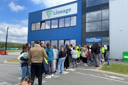 Families gathered outside the Lineage facility in Harnes, France during Family Day, preparing for tours and activities celebrating team pride and connection.