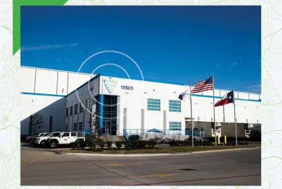 Exterior of a Lineage cold storage facility in Houston, Texas, featuring U.S. and Texas flags, representing Lineage’s Central and Gulf Coast logistics network.