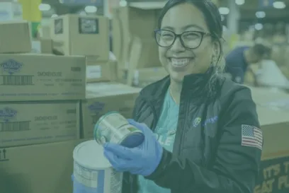 A volunteer working to organize and distribute food