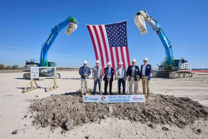A group of men hold shovels during a groundbreaking ceremony.