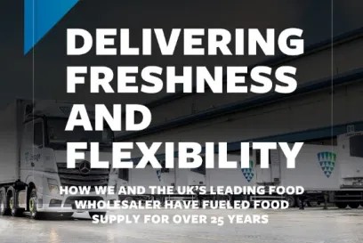 Lineage refrigerated trucks at a UK food wholesaler distribution facility highlighting a 25-year temperature-controlled logistics partnership.