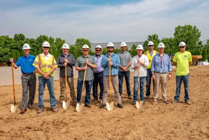 A group of people stand with shovels during a groundbreaking ceremony at a Lineage site in KY