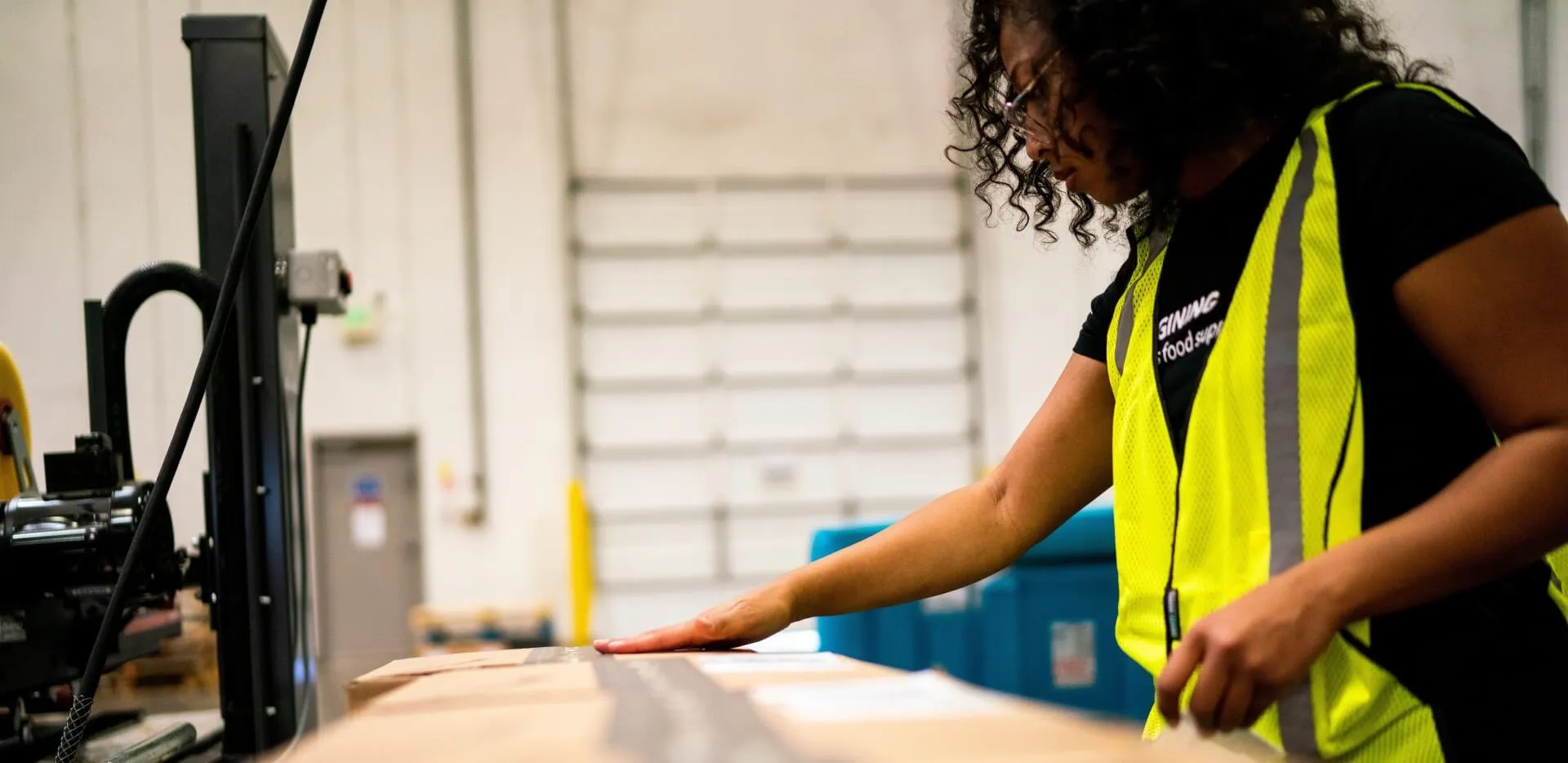 Lineage team member sealing a temperature-controlled direct-to-consumer shipment in a fulfillment center.