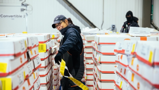 Women labeling pallets in ballcap