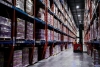 Interior of a Lineage cold storage warehouse with racks, pallets, and a forklift visible.